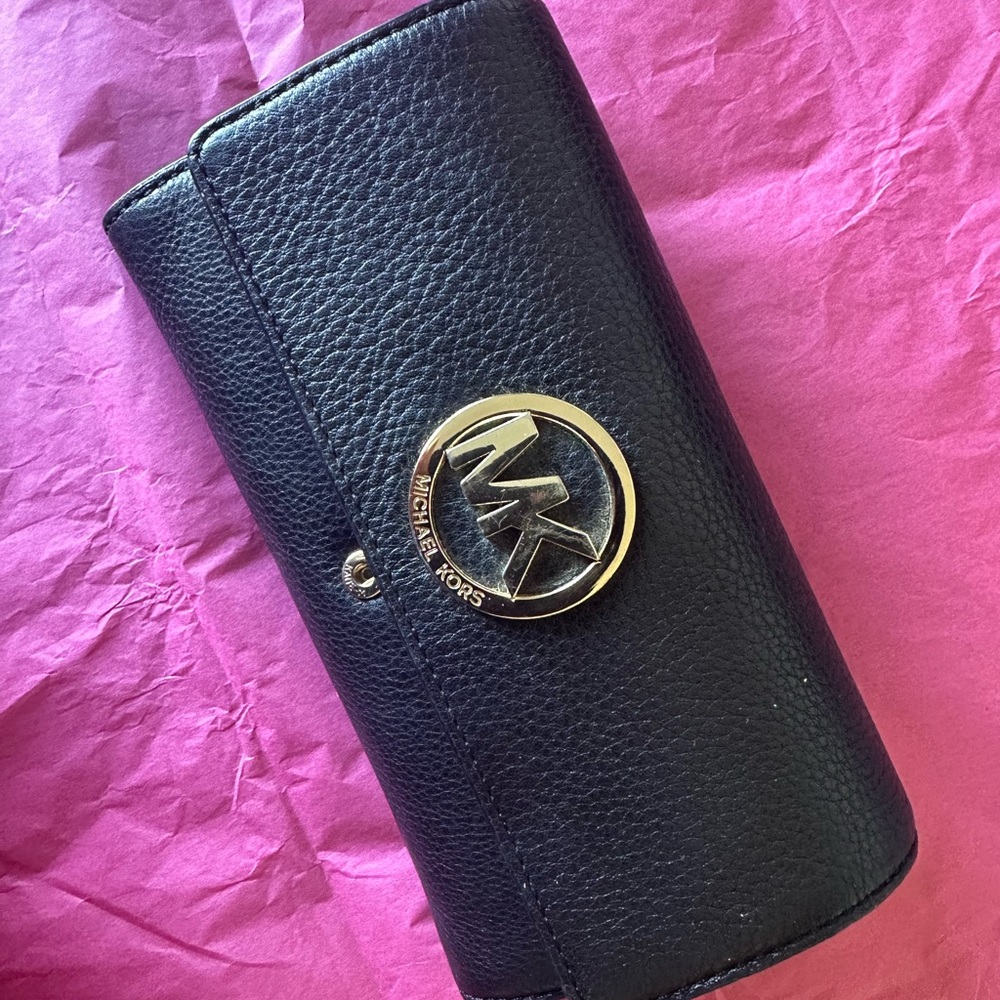 Black envelope wallet with gold logo accent